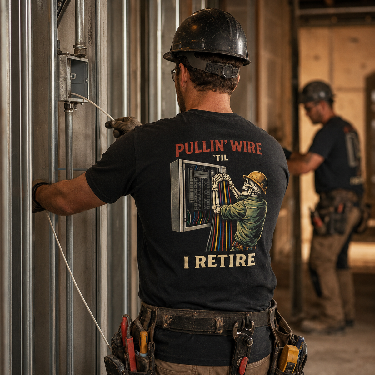 Electrician wearing Pullin Wire Til I Retire tee